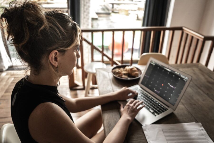 Young woman using laptop working at home