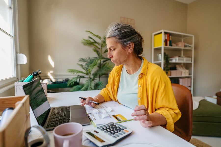 Photo of a woman calculating and paying online her life insurance.