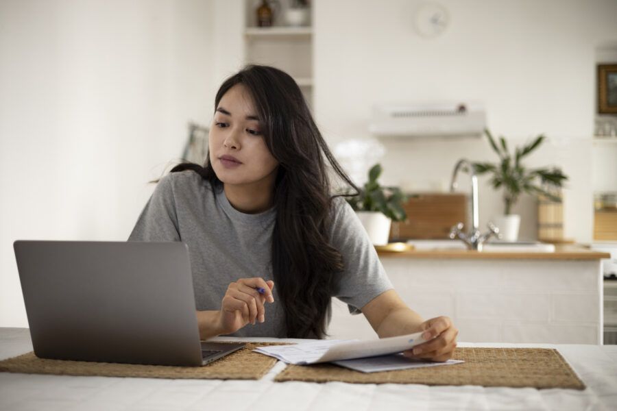 Young woman looking at her mortgage payments on her laptop
